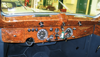 Retored walnut veneering on a classic car on display at Upper Classics NZ.