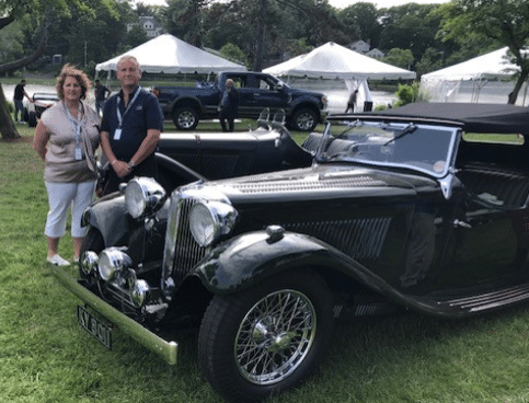 Owners of Upper Classics NZ stand next to a restored SS Jaguar